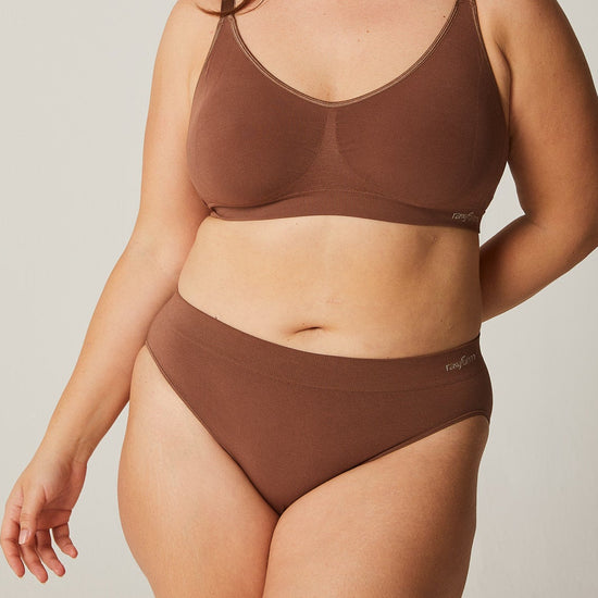 Woman wearing a brown bikini set against a plain background