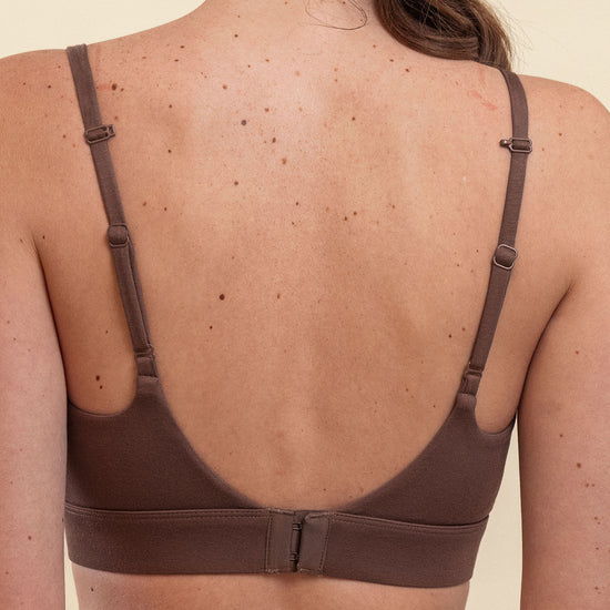 Brown bra worn by a person on a beige background